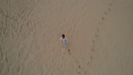Woman-walking-on-the-beach-of-Tarifa,-Spain