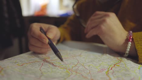 Detail-of-a-man's-hand-over-a-map,-looking-for-new-destinations-and-a-way