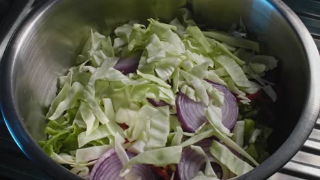 Cierre-El-Chef-Llenando-Un-Bol-Con-Verduras-Mientras-Prepara-Una-Ensalada-De-Atún