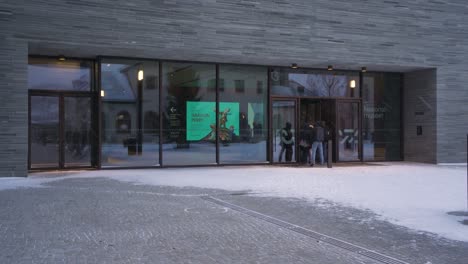 People-Entering-The-National-Museum-of-Art,-Architecture,-and-Design-In-Oslo,-Norway-During-Winter