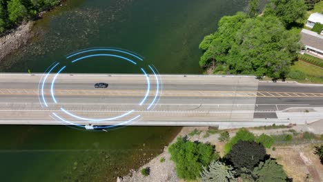 Aerial-view-of-a-self-driving-car-passing-over-a-bridge