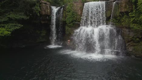 Indigenous-man-climbing-jungle-waterfall