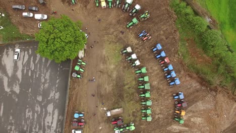 Aerial-top-view-of-new-truck-tractor-cars-parking-for-sale-stock-lot-row,-dealer-inventory-import-and-export-business-commercial