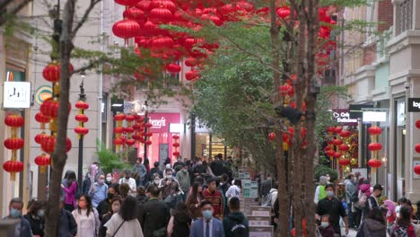 Pedestrians-and-shoppers-walk-past-decorative-Chinese-lanterns-hanging-from-the-ceiling-to-celebrate-the-Chinese-Lunar-New-Year-festival-at-a-retail-street-in-Hong-Kong