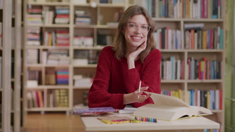 Medium-shot-of-smiling-caucasian-girl-studying-at-library,-slomo