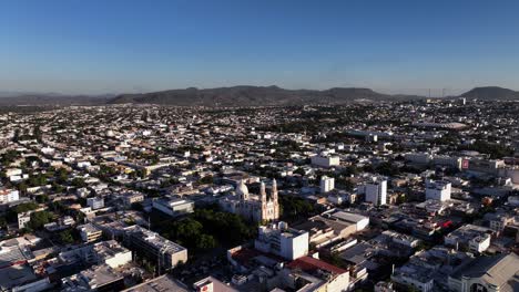 Cathedral-in-Culiacan-Rosales,-golden-hour-in-Sinaloa,-Mexico---orbit,-aerial-view