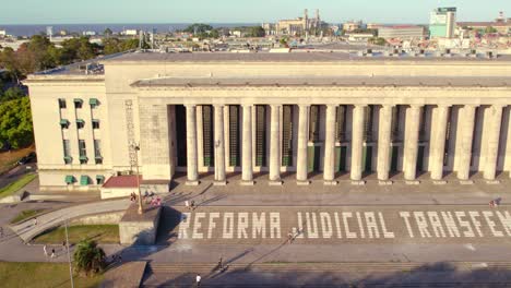 Aerial-view-truck-right-of-the-UBA-law-school-with-the-neoclassical-design-and-Greco-Roman-influence,-with-the-current-protest-of-the-transfeminist-judicial-reform,-slow-motion