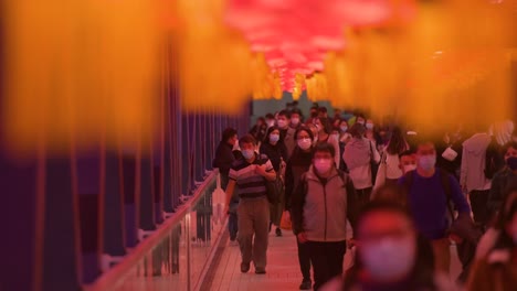 Chinese-commuters-are-seen-walking-through-a-pedestrian-bridge-decorated-with-Chinese-red-lanterns-hanging-from-the-ceiling-to-celebrate-the-Chinese-Lunar-New-Year-festival-in-Hong-Kong