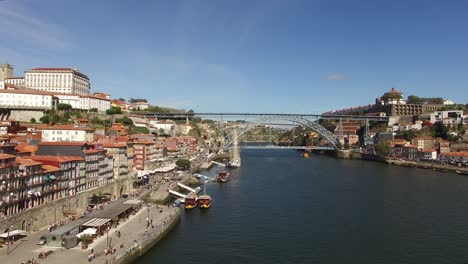 Flying-Over-Porto-with-Famous-Dom-Luis-I-Bridge,-River-Douro-and-Ribeira-Houses