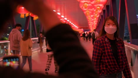 A-girl-poses-for-a-photo-at-a-pedestrian-bridge-decorated-with-Chinese-red-lanterns-hanging-from-the-ceiling-to-celebrate-the-Chinese-Lunar-New-Year-festival-in-Hong-Kong