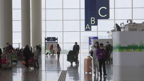 Passagiere-Und-Reisende-Gehen-Durch-Die-Check-in--Und-Abflughalle-Der-Fluggesellschaft-Auf-Dem-Internationalen-Flughafen-Chek-Lap-Kok-In-Hongkong