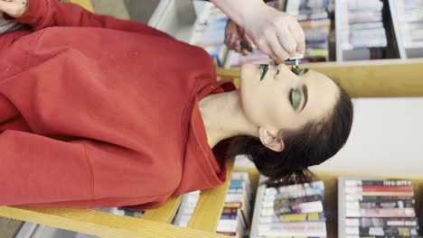 dark-haired-women-getting-make-up-done---Vertical-Video