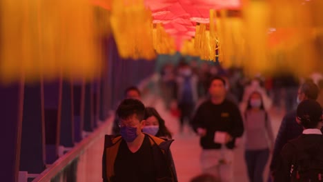 Chinese-commuters-are-seen-walking-through-a-pedestrian-bridge-decorated-with-Chinese-red-lanterns-hanging-from-the-ceiling-to-celebrate-the-Chinese-Lunar-New-Year-festival-in-Hong-Kong