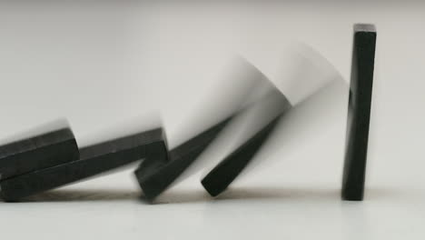 black-dominoes-row-falling-down-in-studio