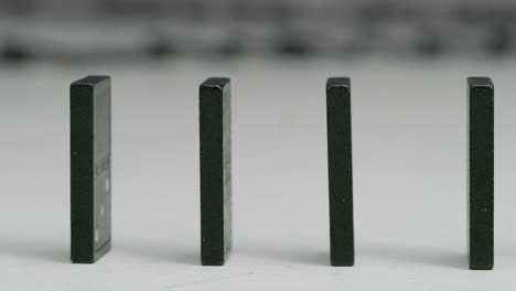 row-of-black-dominoes-in-studio