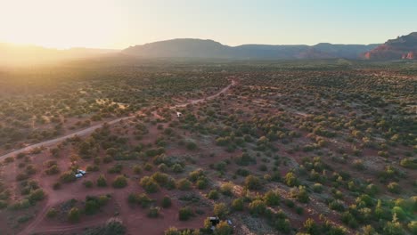 Lands-With-Growing-Bushes-In-Sedona,-Arizona-At-Sunset---drone-shot