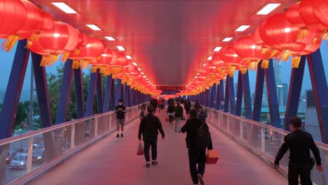 Chinese-pedestrians-are-seen-walking-through-a-pedestrian-bridge-decorated-with-Chinese-red-lanterns-hanging-from-the-ceiling-to-celebrate-the-Chinese-Lunar-New-Year-festival-in-Hong-Kong