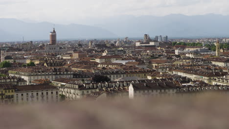 Soft-dolly-over-Turin-skyline-with-moving-blurry-foreground