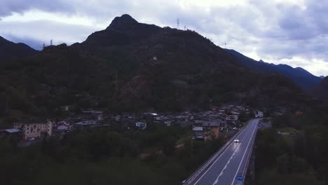 Aerial-drone-shot-of-a-small-hill-in-front-of-a-scenic-typical-Italian-alp-village