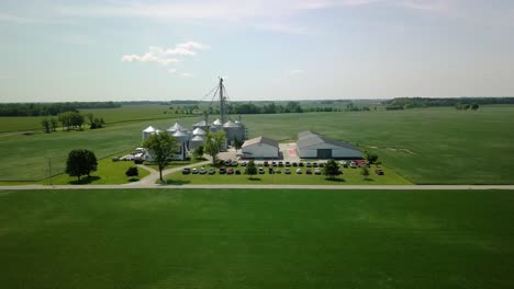 Aerial-view-descending-to-rural-farm-with-grain-silo-storage,-Arcadia,-Indiana-farming-landscape