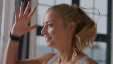 Side-close-up-of-face-and-hands-of-woman-running-in-place-at-workout