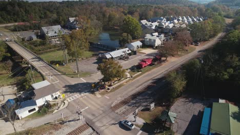 Aerial-approaching-waterfall-surrounded-by-shops-and-suburbs-in-Old-Town-Helena,-Alabama