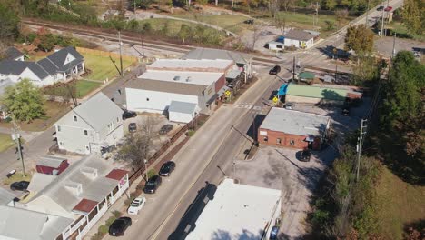 Aerial-pass-over-shops-and-railroad-tracks-in-Old-Town-Helena,-Alabama