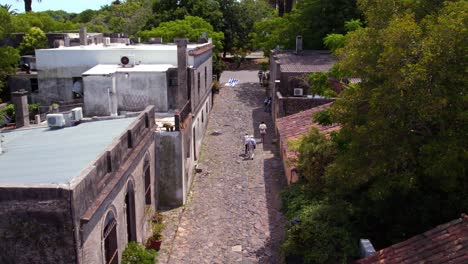 Aerial-View-Of-People-On-Calle-De-Los-Suspiros---Historical-Street-In-Colonia-Del-Sacramento-In-Uruguay