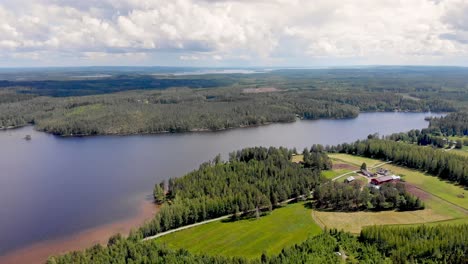 Panoramic-aerial-view-of-a-Finnish-lake-and-islands-and-countryside-on-a-beautiful-summer-day
