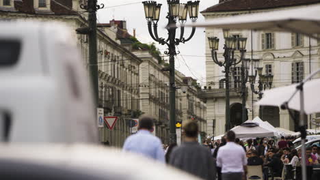 People-at-outside-serving-in-city-centre-of-Turin-in-Italy