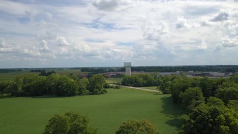 Terra-Haute,-Indiana-farming-landscape-aerial-view-orbiting-water-tower-in-the-distance