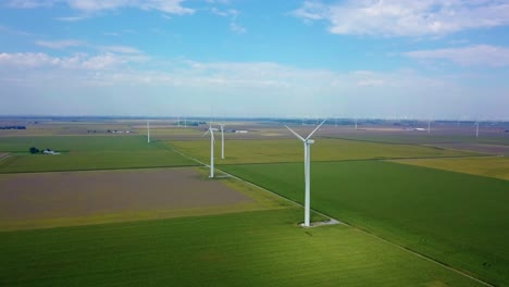 Aerial-view-rising-above-idyllic-green-Lafayette-farmland-and-alternative-energy-wind-turbines