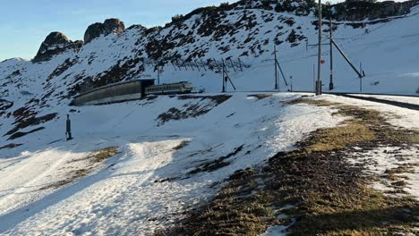 Mountain-cog-railway-train-carriage-leaving-the-summit-stop-in-winter