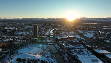 Aerial-drone-shot-of-sunset-moving-backwards-over-Commons-Park,-Denver