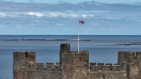 Flag-of-England-flying-in-the-wind-at-Bamburgh-Castle
