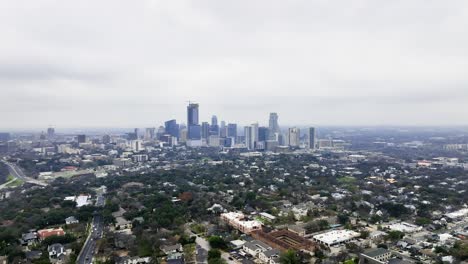 Austin-city-skyline,-dark,-fall-day-in-Texas,-USA---wide,-panoramic,-Aerial-view