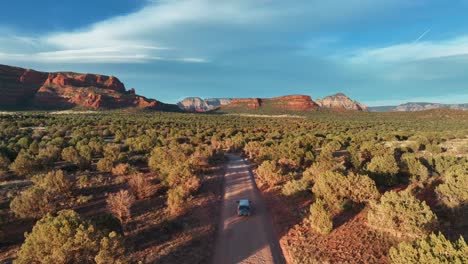 Vehicle-Traveling-On-The-Scenic-Landscape-Of-Sedona-Arizona-In-United-States---aerial-drone-shot