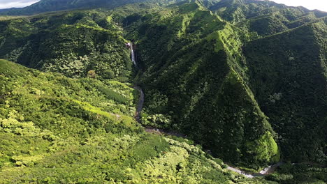 Aerial-View-of-Helicopter-and-Waterfall-in-Rolling-Hills-and-Green-Landscape-in-Kauai-Hawaii