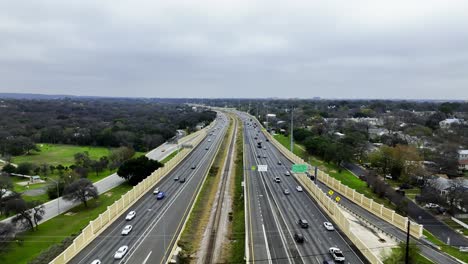 Aerial-view-of-traffic-on-a-multilane-highway,-cloudy-fall-day-in-Austin,-Tx,-USA