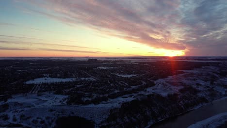 Drone-footage-of-Calgary's-real-estate-during-a-beautiful-winter-sunrise-with-god-rays