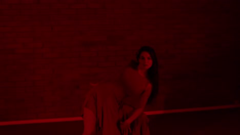 Seductive-female-dancer-dancing-in-a-dark-red-room-inside