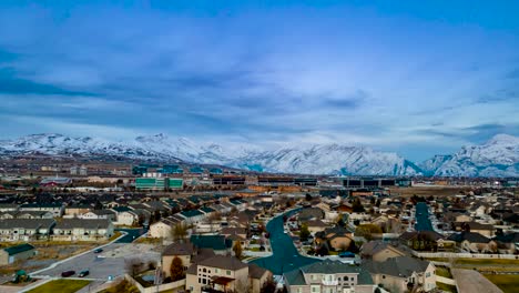 Lehi,-Utah-and-Silicon-Slopes-in-Winter-with-snow-in-the-mountains---aerial-hyper-lapse-at-twilight