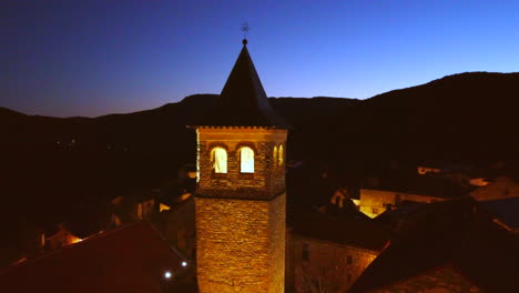 Orbital-flight-over-a-church-n-a-Mountain-Village-in-the-Spanish-Pyrenees-at-sunset