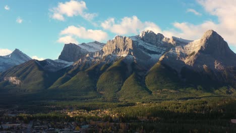 Drone-shot-of-epic-mountain-peaks-in-the-Canadian-Rocky-Mountains-town-of-Canmore-at-sunrise