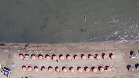 Excellent-drone-shot.-Beach,-umbrellas-and-beautiful-sea