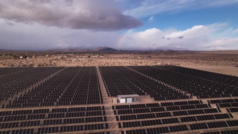 aerial-footage-of-photovoltaic-solar-panel-farm-installation-in-Joshua-Tree-national-park-California,-eco-sustainable-green-energy-from-sunshine