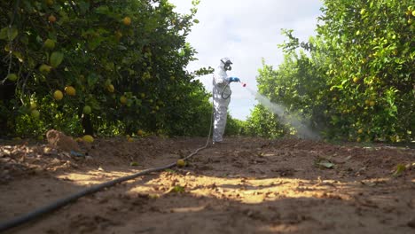Farmer-in-protective-clothes-spray-pesticides