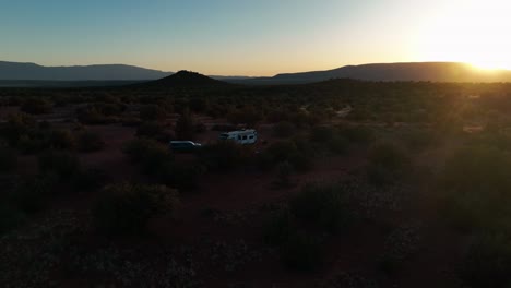 RV-In-The-Desert-Landscape-Of-Sedona-In-Arizona-During-Sunset---aerial-pullback