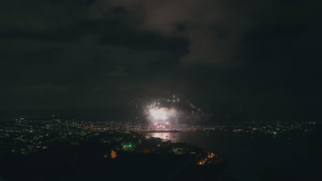 A-shot-captures-the-spectacular-display-of-fireworks-lighting-up-the-night-sky,-viewed-from-a-hilltop-vantage-point,-providing-panoramic-view-of-the-vibrant-colors-and-of-the-pyrotechnics