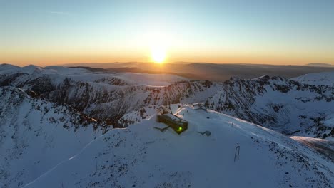 Drone-shot-of-Musala-peak-during-sunrise,-Bulgaria,-Rila-mountain,-highest-summit-on-the-Balkans,-clear-weather,-clear-sky,-amazing,-stunning,-golden-hour,-blue-hour,-dawn